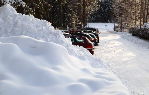 autot parkissa lumisella tiellä