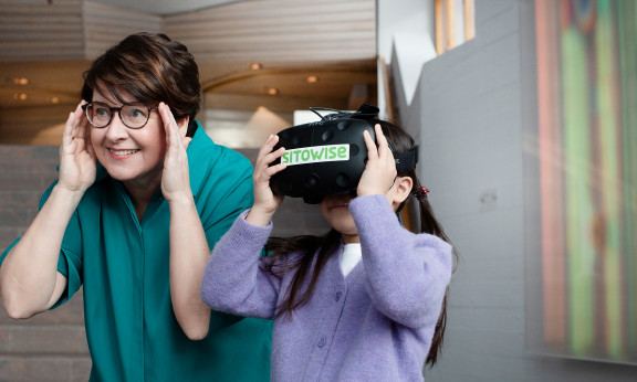 a woman and a child using vr glasses